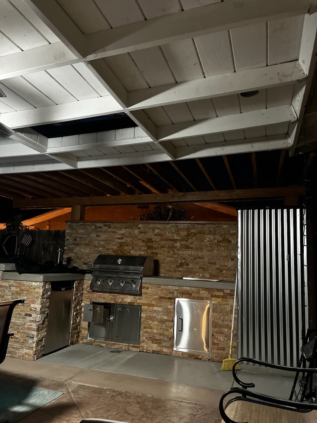 Covered outdoor kitchen with pergola and built-in BBQ grill