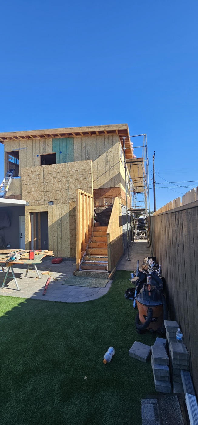 New build with OSB sheathing and scaffolding under blue sky