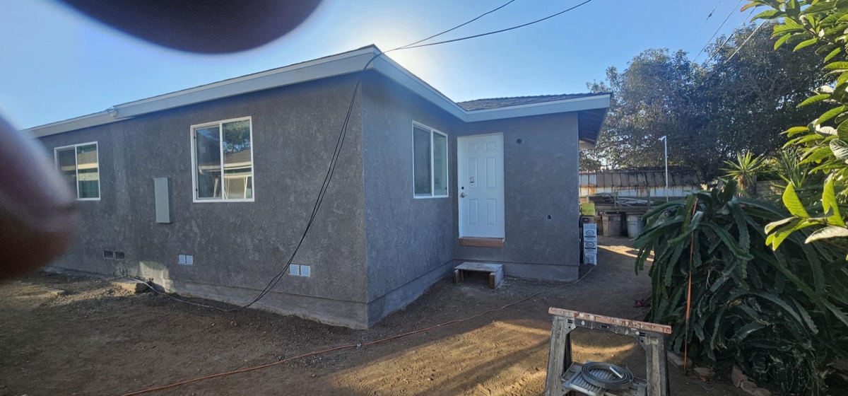 Completed ADU with grey stucco exterior finish