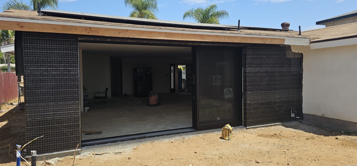Modern ADU under construction with large sliding glass doors installed