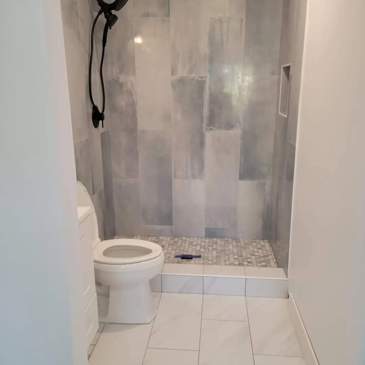 Luxury bathroom with double vanity, gold fixtures and arched mirrors