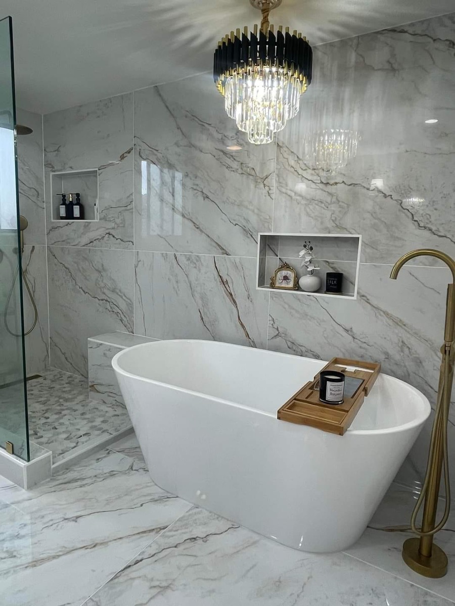 Luxury marble bathroom with freestanding soaking tub and gold fixtures